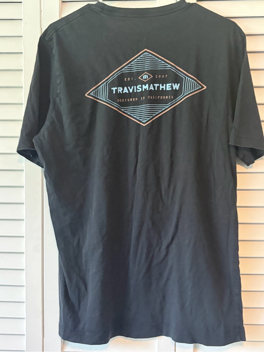 Travis Mathew Black Short-Sleeve Tee with Teal and Copper Back Logo